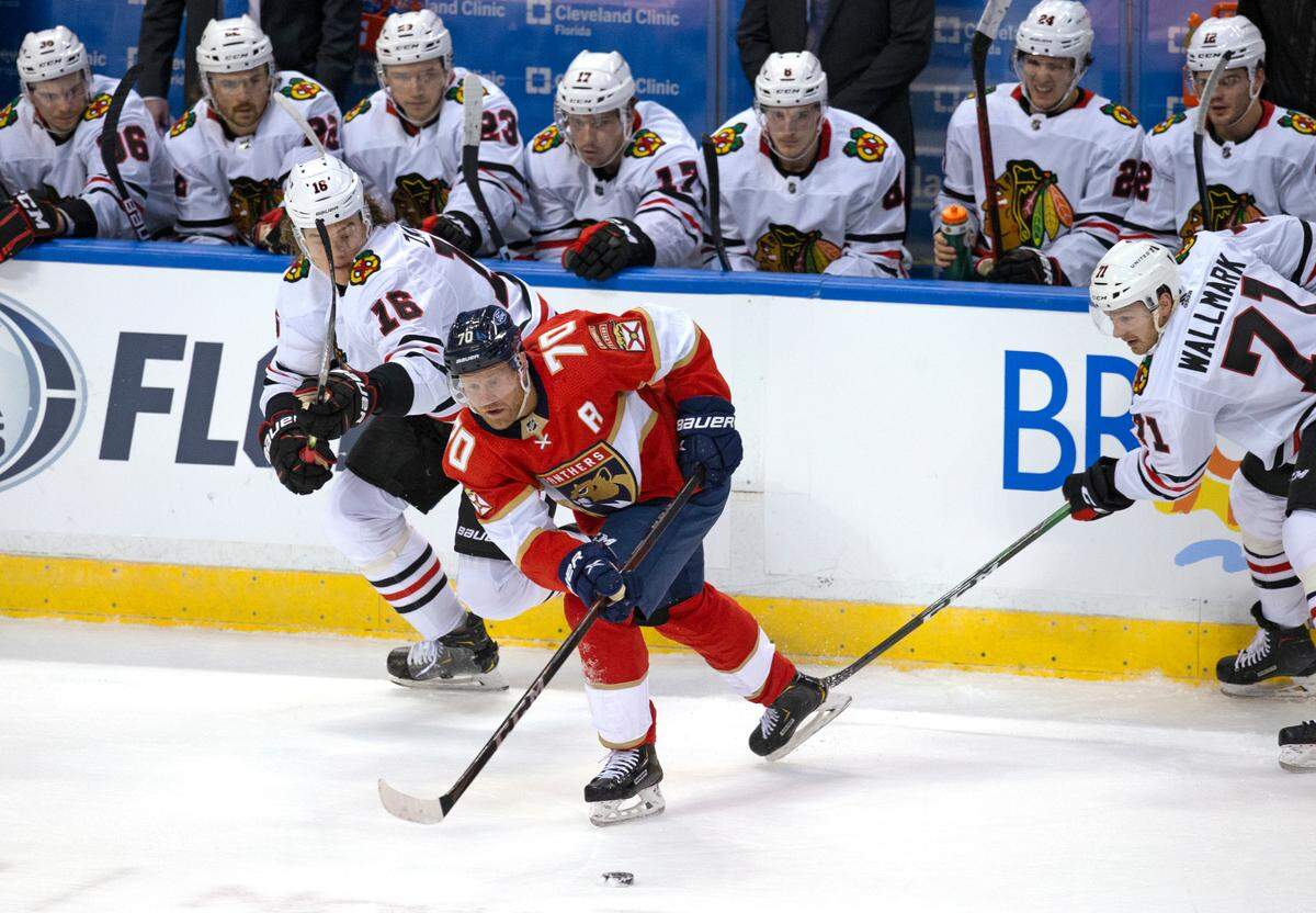 Florida Panthers right wing Patric Hornqvist (70) go for the puck against Chicago Blackhawks defenseman Nikita Zadorov (16) and Lucas Wallmark (71) during the first period of the Florida Panthers NHL home opener game at the BB&T Center on Sunday, January 17, 2021 in Sunrise, Fl.