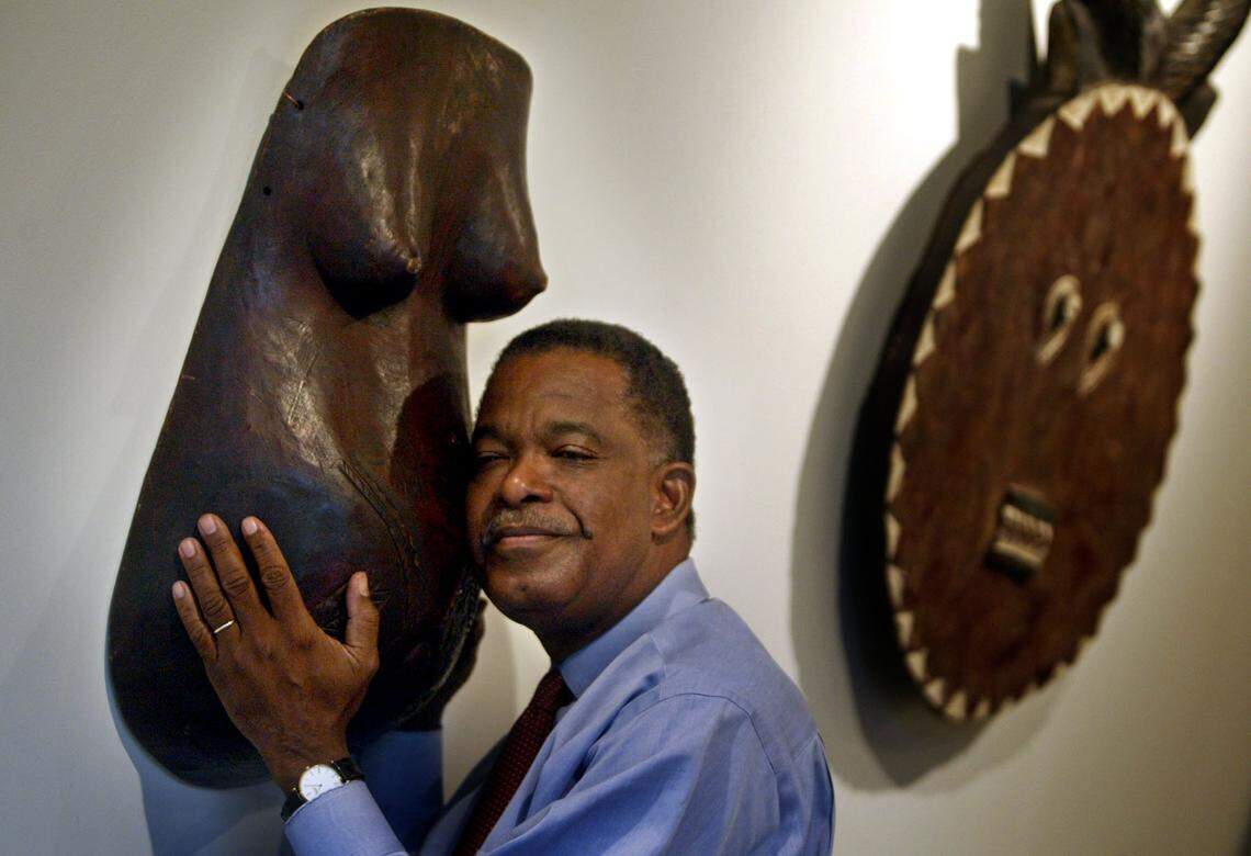 Architect Neil Hall seen in a 2005 photo embracing a casting of fertility worn by Tribal men when their wives are pregnant. Hall is the force behind Art Africa and the catalyst for the Black Miami art scene during Miami Art Week.