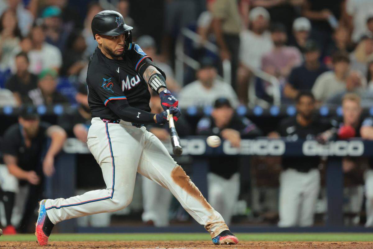 Aug 1, 2025; Miami, Florida, USA; Miami Marlins catcher Agustin Ramirez (50) hits an RBI single against the New York Yankees during the seventh inning at loanDepot Park. Mandatory Credit: Sam Navarro-Imagn Images