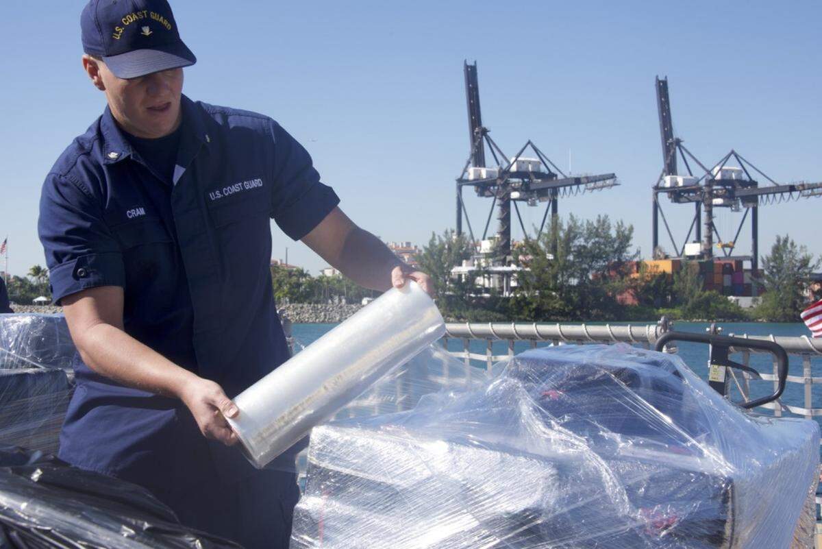 Coast Guard Petty Officer 3rd Class Mason R. Cram wraps a palette of cocaine in preparation for a drug offload March 22, 2019, at Coast Guard Base Miami Beach. The crew of the Coast Guard Cutter Tampa offloaded approximately 27,000 pounds of cocaine worth an estimated $360 million wholesale seized in international waters in the Eastern Pacific Ocean.