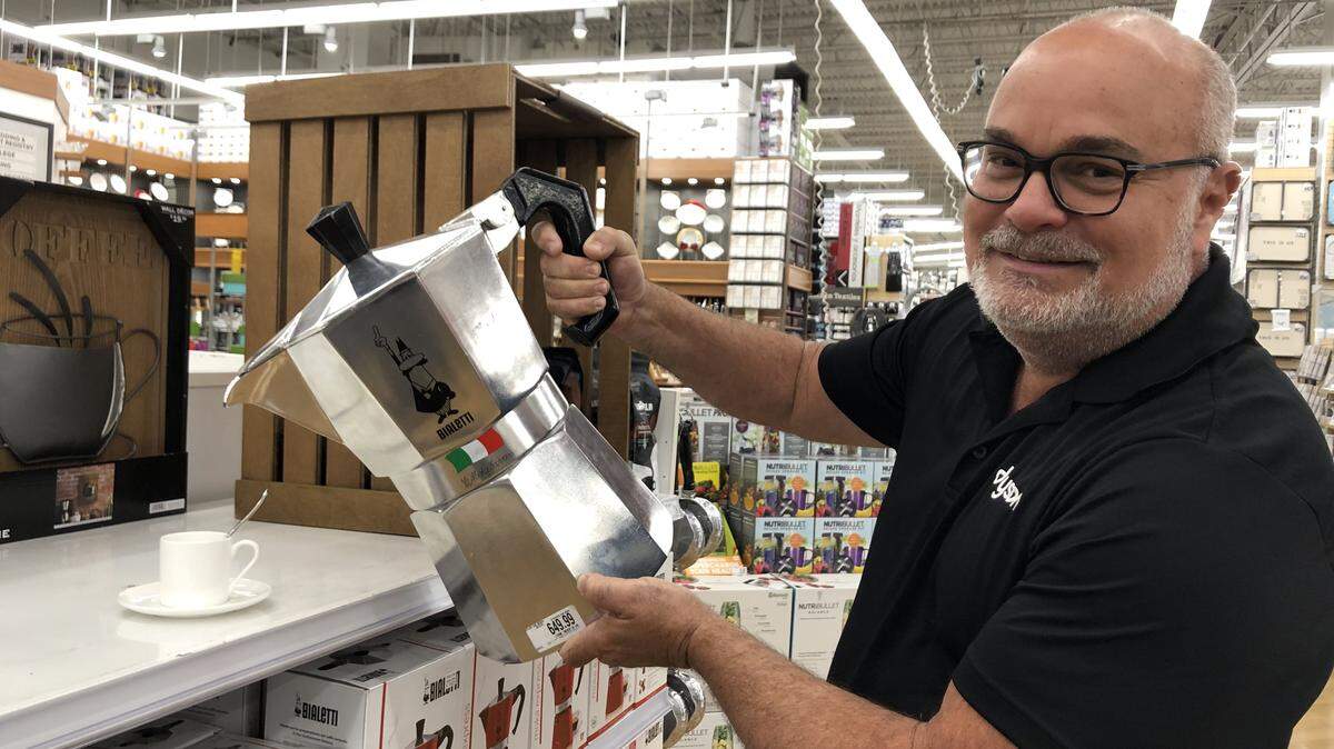 Gus Lopez grabbles with the enormous 50-cup Biletti stovetop espresso maker.