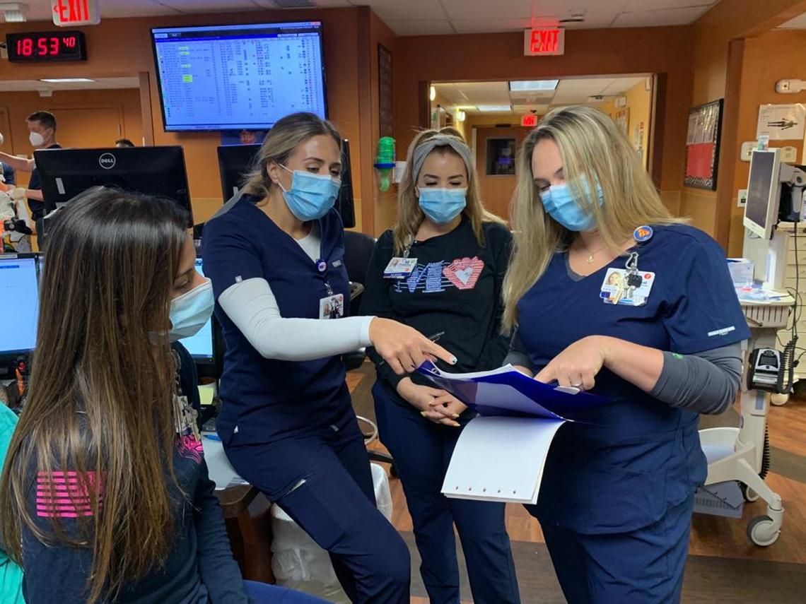  Nurses Jannie Garcia, Jordan Pflum, Yudi Herrera, and Kristin Percival Schmalz&nbsp;review staffing and operational plans in a pre-shift team huddle at Memorial Hospital Pembroke in this file photo.
