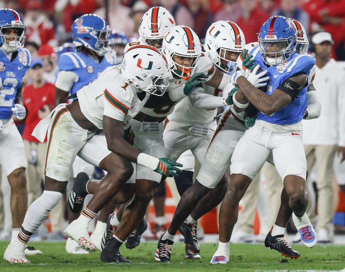 The Miami Hurricanes defense takes down Mississippi Rebels running back Kewan Lacy (5) during the first half of a College Football Playoff semifinal in the Fiesta Bowl at State Farm Stadium on Thursday, January 8, 2026 in Glendale, Arizona.
