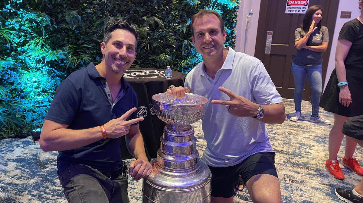 Joshua Abril of Fookem’s Fabulous in Coconut Grove and Florida Panthers goaltending coach Robb Tallas with the Stanley Cup at Tallas’ Parkland home.