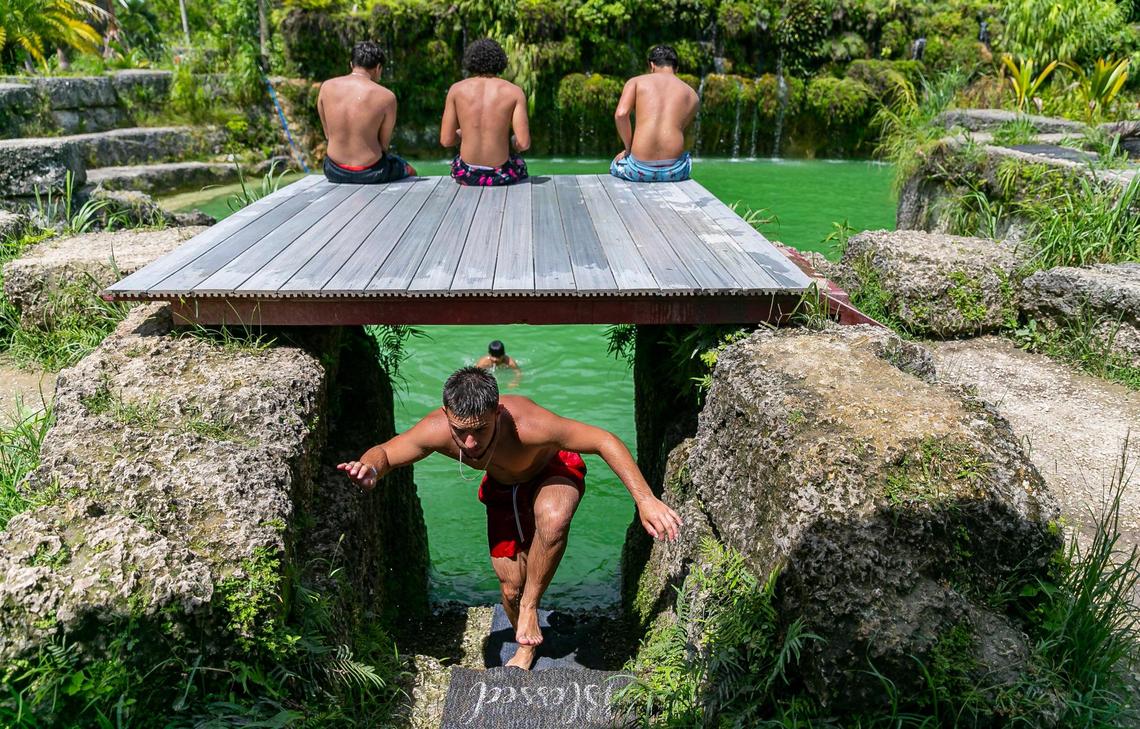 Addiel Gil, 18, center, makes his way back to a jumping platform.