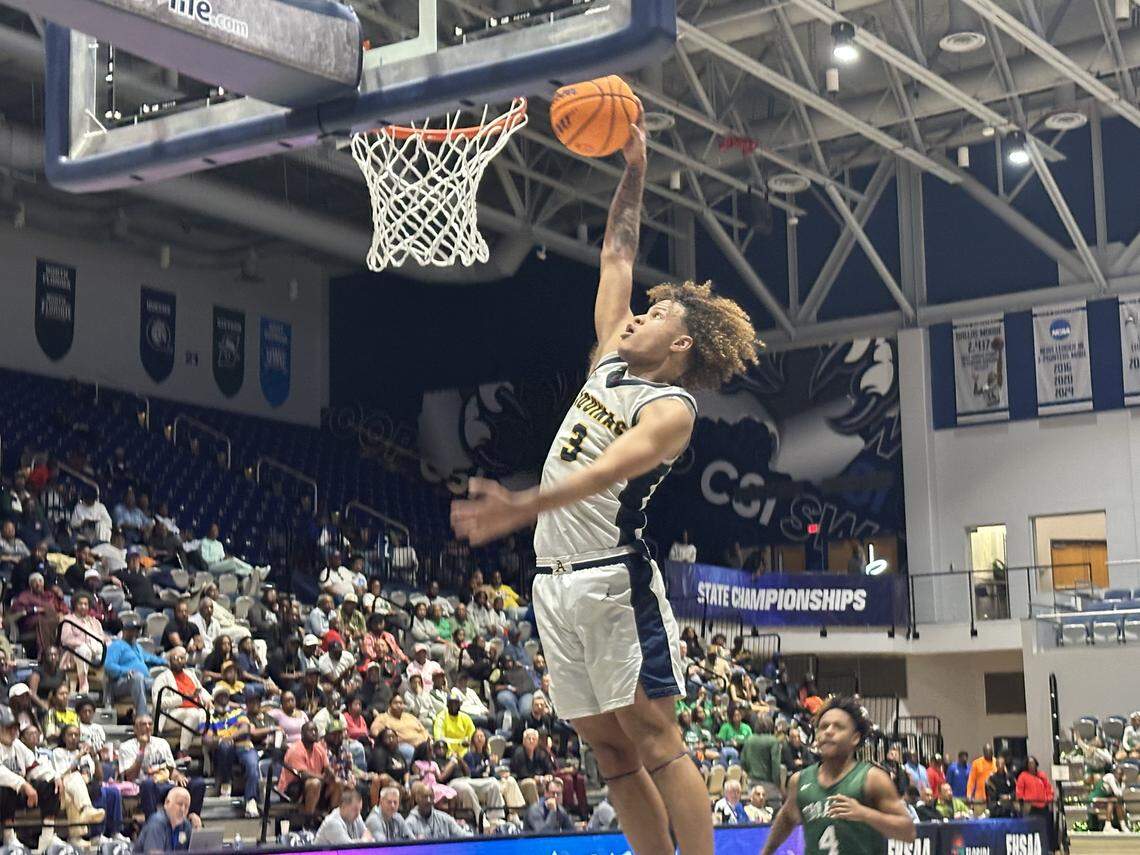 St. Thomas Aquinas’ KJ Sandi emphatically dunks for the final bucket of Saturday’s Class 6A state boys’ basketball championship victory over Orlando Evans at UNF Arena in Jacksonville, Fla.