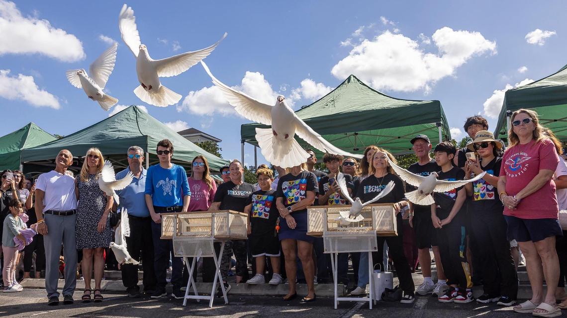 Family members of some victims of the Marjory Stoneman Douglas shooting watch as doves are released during the ‘Forever in Our Hearts’ commemoration event outside Eagles’ Haven Wellness Center on Friday, Feb. 14, 2025, in Coral Springs, Fla. The event aims to honor the 17 lives lost during the Marjory Stoneman Douglas High School shooting in 2018 and their families.