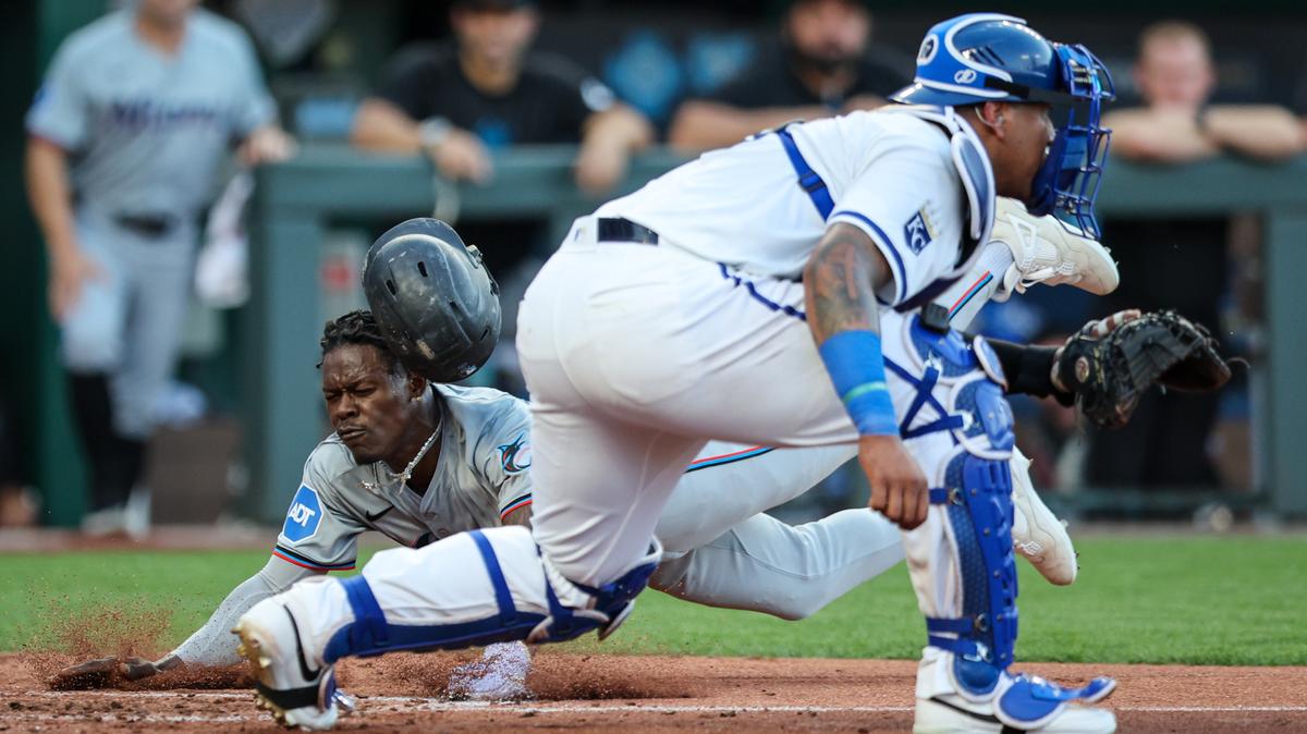 Jun 24, 2024; Kansas City, Missouri, USA; Miami Marlins outfielder Jazz Chisholm Jr. (2) dives across home plate to score during the third inning against the Kansas City Royals at Kauffman Stadium. Mandatory Credit: William Purnell-USA TODAY Sports