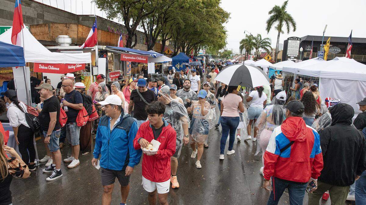Crowds of people filled 8th street in Little Havana despite the relentless rain during Calle Ocho festival on Sunday, March 15, 2026 . Andrew Uloza / for Miami Herald