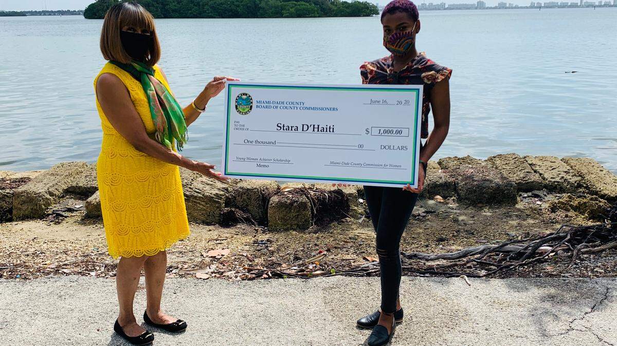 The Miami-Dade County Commission for Women recently honored Stara D’Haiti from the Young Women’s Preparatory Academy, right, for winning the $1,000 Young Woman Achiever Scholarship. She was honored during a ceremony featuring Chairwoman Sharon Kendrick-Johnson, left.