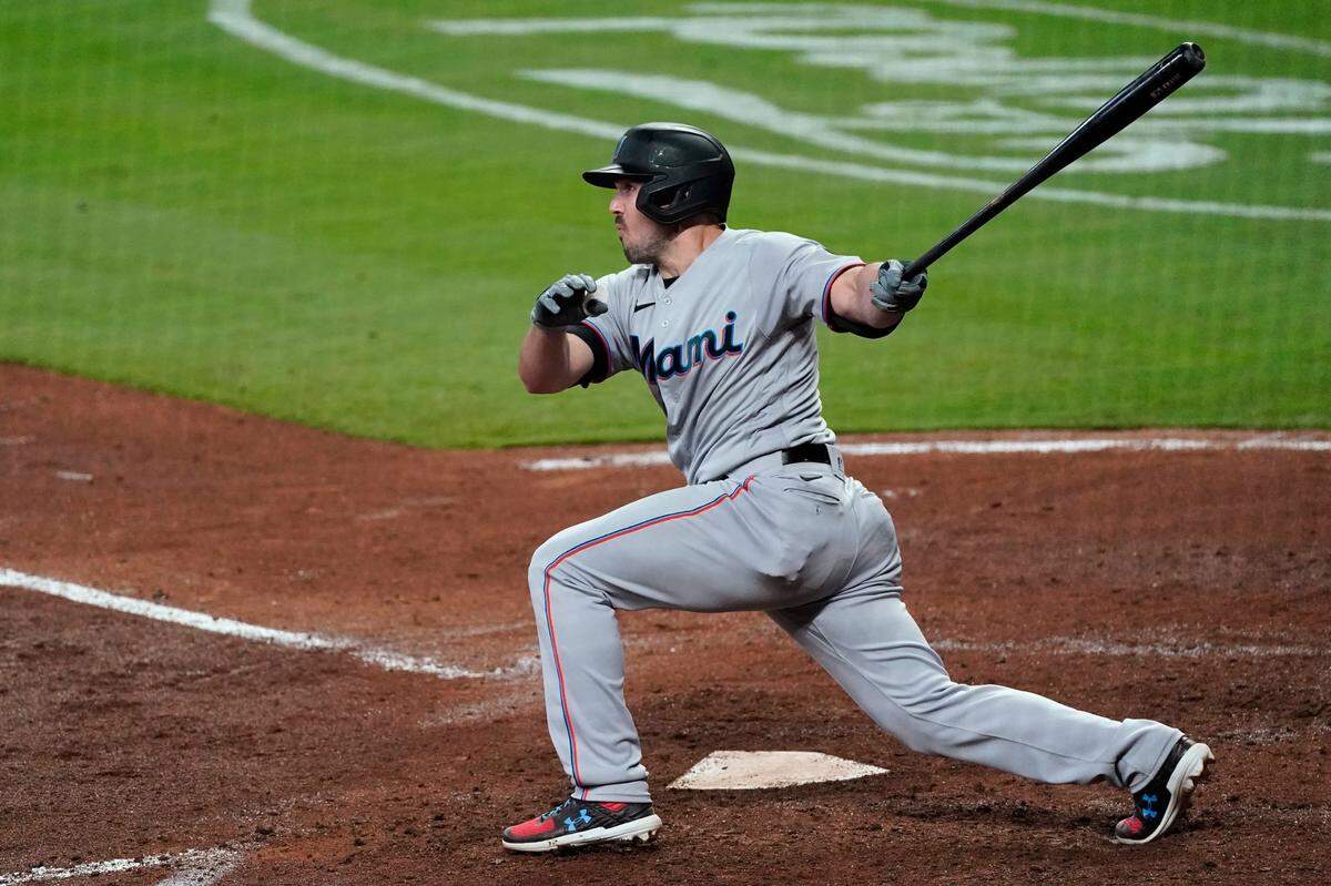 Miami Marlins’ Adam Duvall follows through on a two-run double during the fourth inning of the team’s baseball game against the Atlanta Braves on Tuesday, April 13, 2021, in Atlanta. (AP Photo/John Bazemore)
