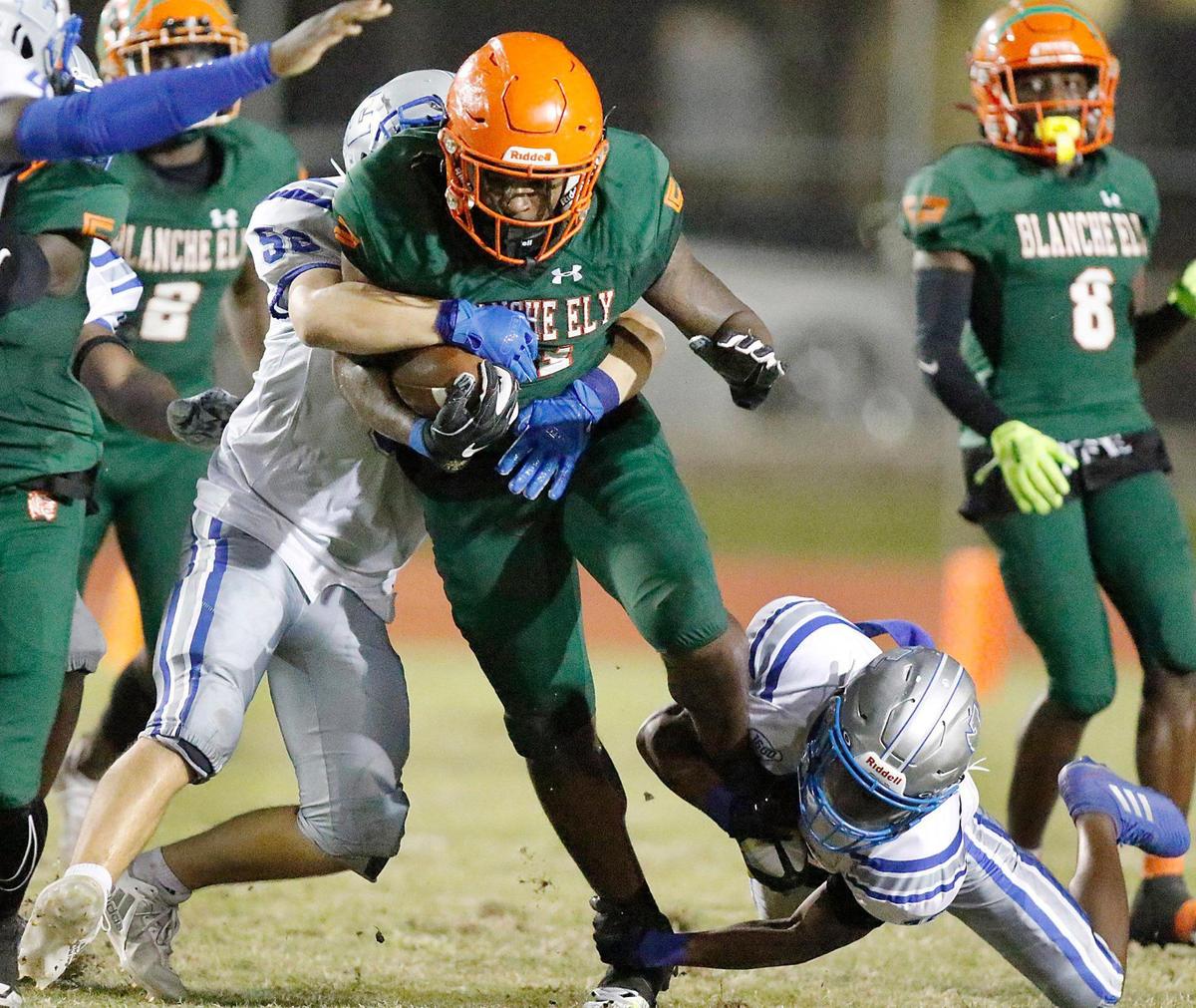 Blanche Ely Tigers Lerry Moise (81) is tackled by Fort Lauderdale Flying L’s defenders during football game on Friday, September 30, 2022 at Blanche Ely HS in Pompano Beach. The Tigers won 36-12.