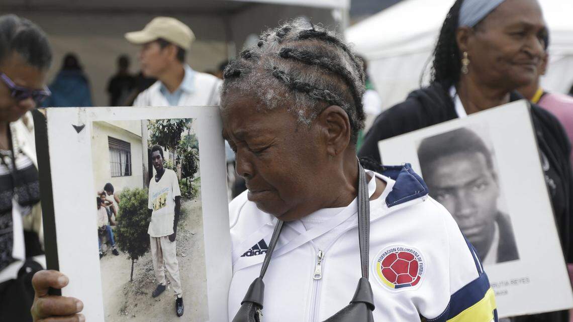 Maria Ruidis holds a photo of her missing son Everth Ibarguen, during an event in Bogota in 2016 to mark the International Day of the Disappeared.