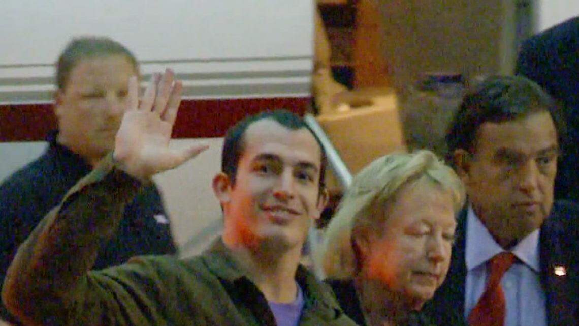 This image taken from a video shows Marine Sgt. Andrew Tahmooressi waving on Saturday, Nov. 1, 2014. Family spokesman Jon Franks told reporters that Tahmooressi arrived at a South Florida airport about 6 a.m. Saturday and was resting with his family at their home in suburban Weston, Fla.