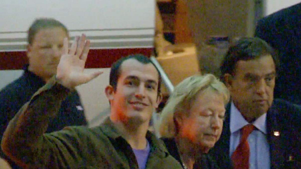 This image taken from a video shows Marine Sgt. Andrew Tahmooressi waving on Saturday, Nov. 1, 2014. Family spokesman Jon Franks told reporters that Tahmooressi arrived at a South Florida airport about 6 a.m. Saturday and was resting with his family at their home in suburban Weston, Fla.