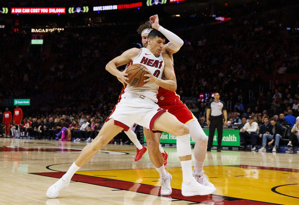 Miami Heat forward Simone Fontecchio (0) drives through Atlanta Hawks forward Corey Kispert (24) during the first half of a game on Tuesday, Feb. 3, 2026, at the Kaseya Center in downtown Miami, Fla.  