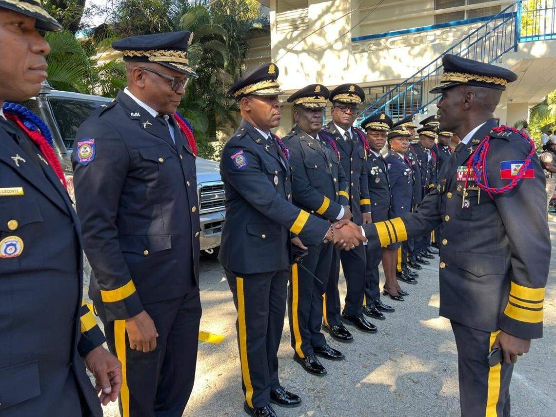 Haiti National Police Director André Jonas Vladimir Paraison, right, greets the high command of the police on Friday, January 23, 2026 before welcoming 877 new graduates of the academy. The rookie cops are the first class in an accelerated, U.S.-supported training program aimed at adding 4,000 officers within 12 months to the beleaguered force trying to take on gangs.