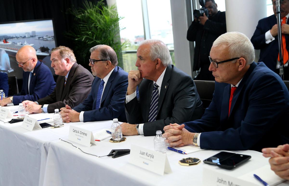 Miami-Dade County Mayor Carlos Gimenez (second from right) and Juan Kuryla (far right) director of PortMiami, joined US. Vice President Mike Pence and Florida Gov. Ron De Santis, during a meeting at Port Everglades with cruise company executives to discuss the coronavirus response on March 7, 2020.