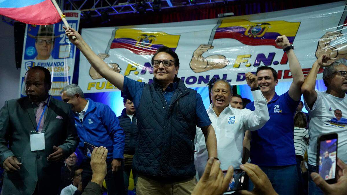 Presidential candidate Fernando Villavicencio waves an Ecuador national flag during a campaign event at a school minutes before he was shot to death in Quito on Aug. 9.