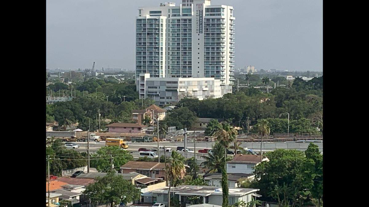 The white minivan/shuttle bus in the foreground of State Road 836 aka the Dolphin Expressway is taking the Northwest 17th Avenue exit, just as drivers will have to during overnight closures for construction until next Thursday.