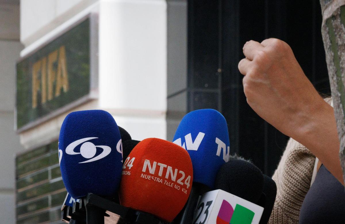 Laura Muñoz makes a fist while speaking during a press conference protesting the presence of ICE agents at FIFA World Cup games on Monday, June 30, 2025, outside the FIFA building in Coral Gables, Florida.