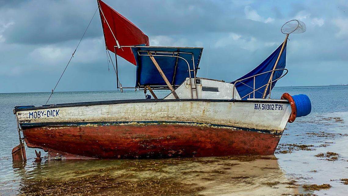 A small fishing vessel named ‘Moby Dick’ is beached on Duck Key in the Florida Keys. It arrived Monday, June 21, 2021, with eight people from Cuba aboard.