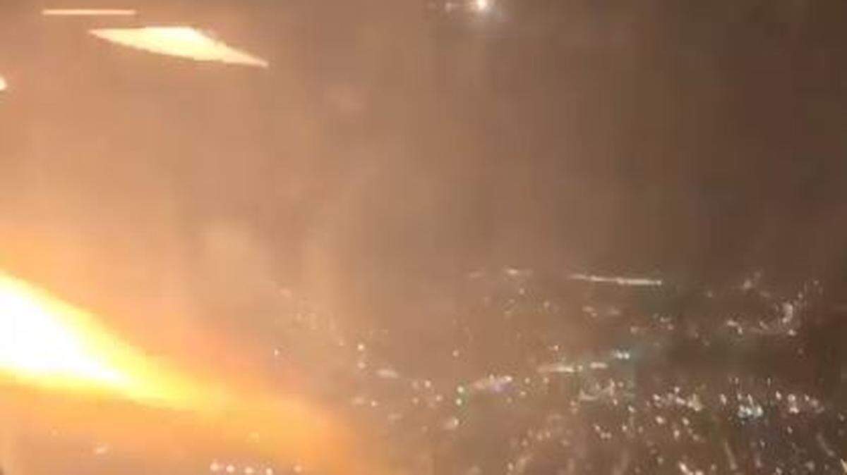 A Los Angeles-bound plane returned to a New Jersey airport Wednesday night after a passenger’s video captured flames shooting from an engine. No one was hurt, United Airlines says.