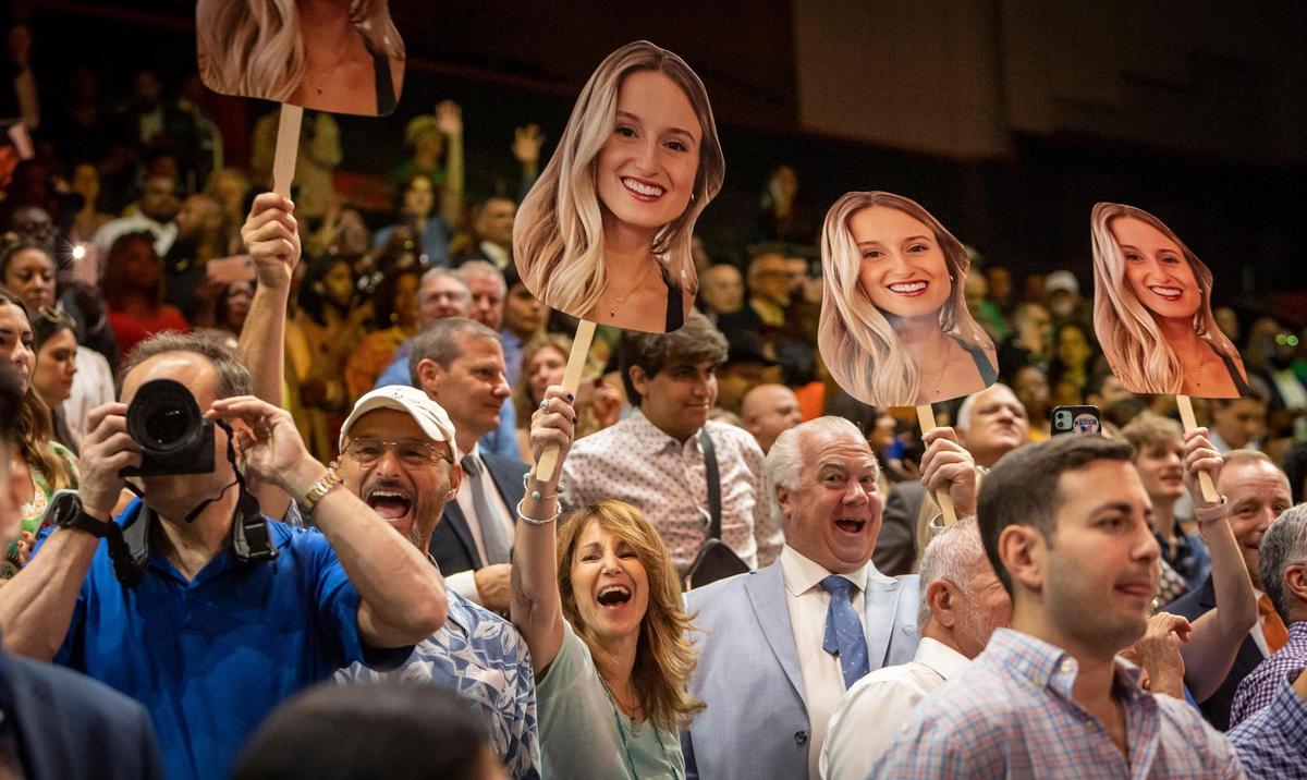 Gillian Drexler’s relatives who traveled from Huntington, New York, greet her with giant photos of her as she enters her commencement ceremony at the Watsco Center. Kim Rhatigan, her mom, said Drexler, 22, maintained her grades and graduated magna cum laude, despite the COVID-19 disruption from her freshman year, which sent her rushing home. “I’m very proud, and I’m very excited because she put a lot of hard work and dedication to get to this point. It was challenging,” Rhatigan said.