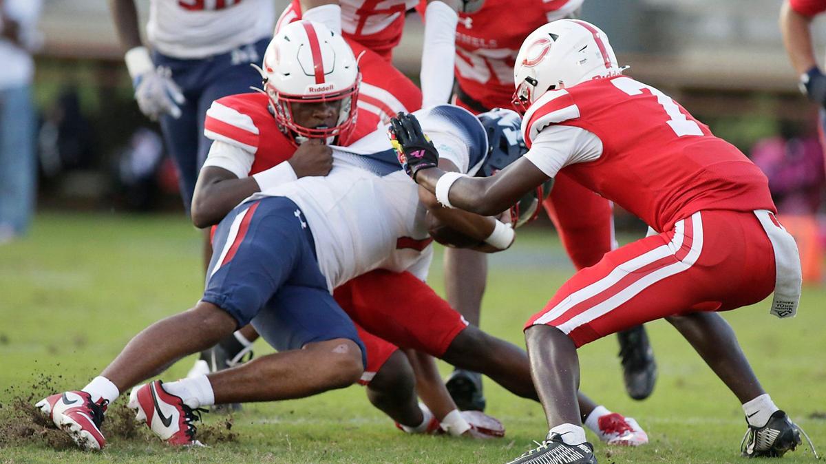 Plantation Colonels defenders take down Miramar Patriots quarterback Jayvin Smart during football game on Friday, August 30, 2024 at PAL Field in Plantation. Andrew Uloza / for Miami Herald
