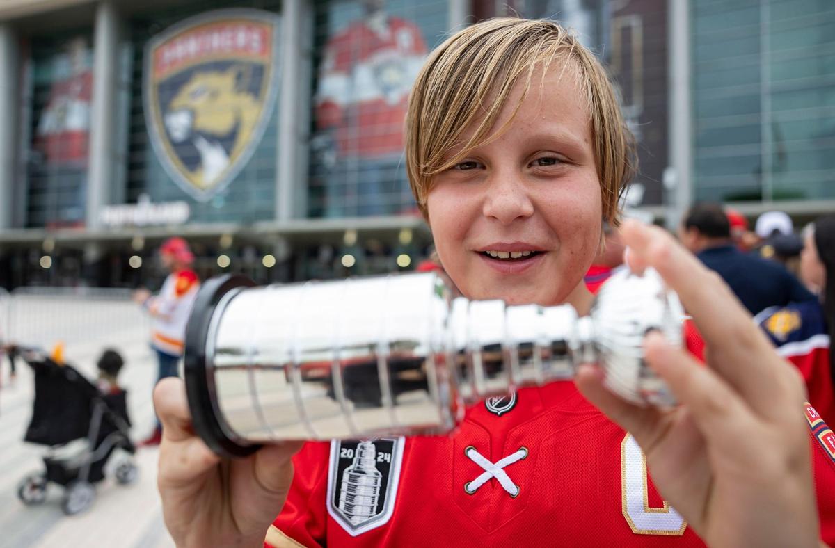 Florida Panthers fan Thor Orbesen, 12, holds a miniature Stanley Cup as he arrives to a watch party at the Amerant Bank Arena to see his team play against the Edmonton Oilers in Game 4 of the NHL Stanley Cup Final