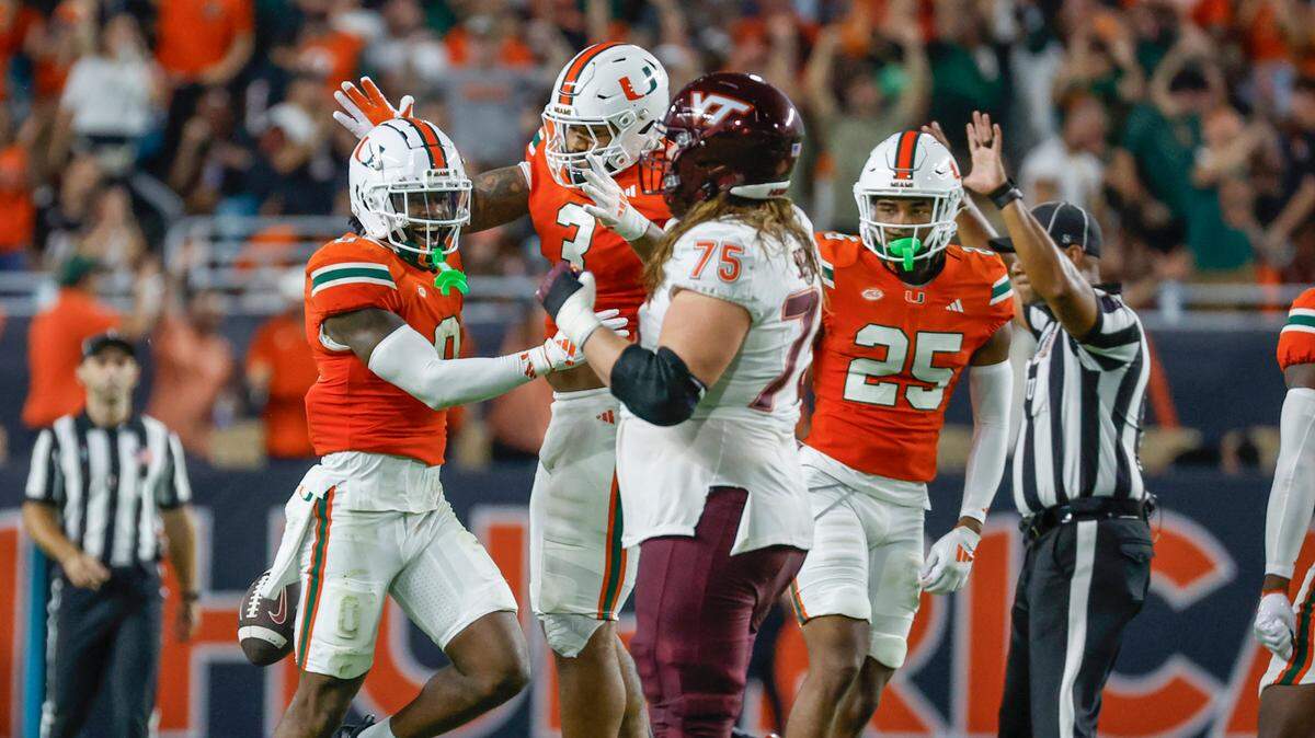Miami Hurricanes defensive back Mishael Powell (0) reacts with teammates after intercepting the ball against the Virginia Tech Hokies during the first half of an ACC conference football game at Hard Rock Stadium on Friday, September 27, 2024, in Miami Gardens, Fla.
