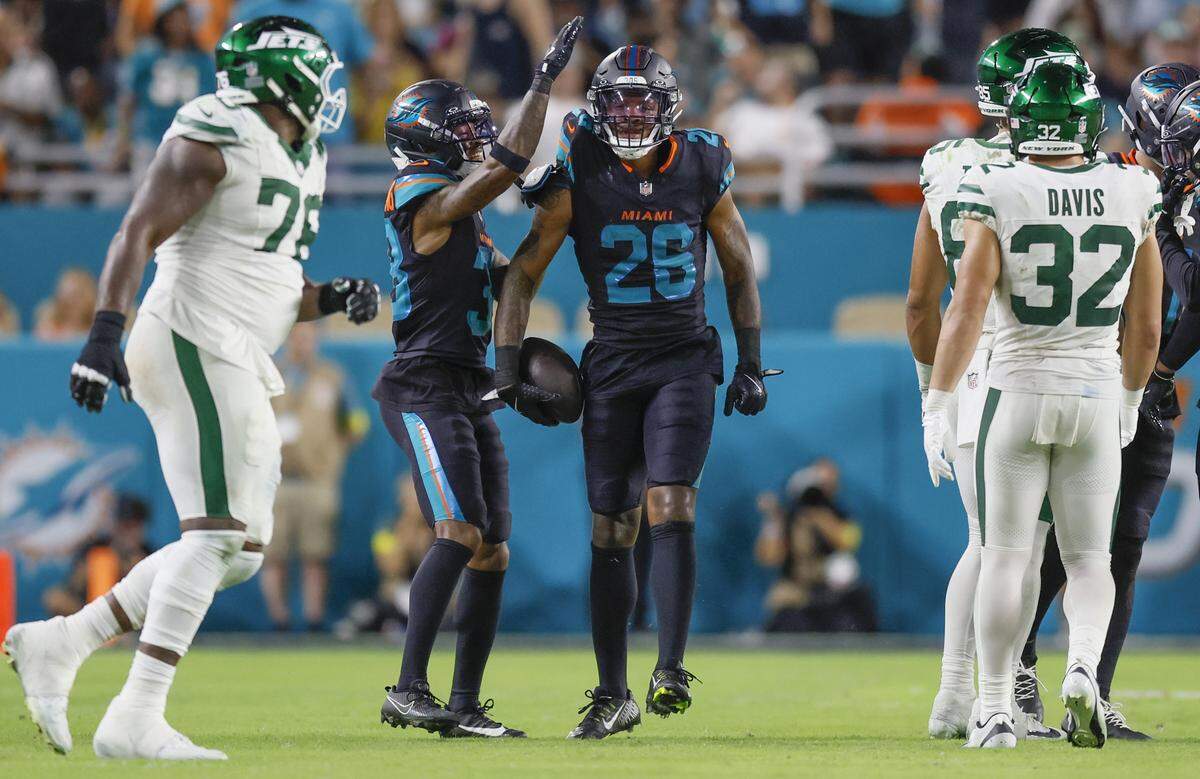Miami Dolphins cornerback Rasul Douglas (26) and Cornell Armstrong (38) reacts during the game against the New York Jets in the second half of their NFL game at Hard Rock Stadium in Miami Gardens, Florida, on Monday, September 29, 2025. 