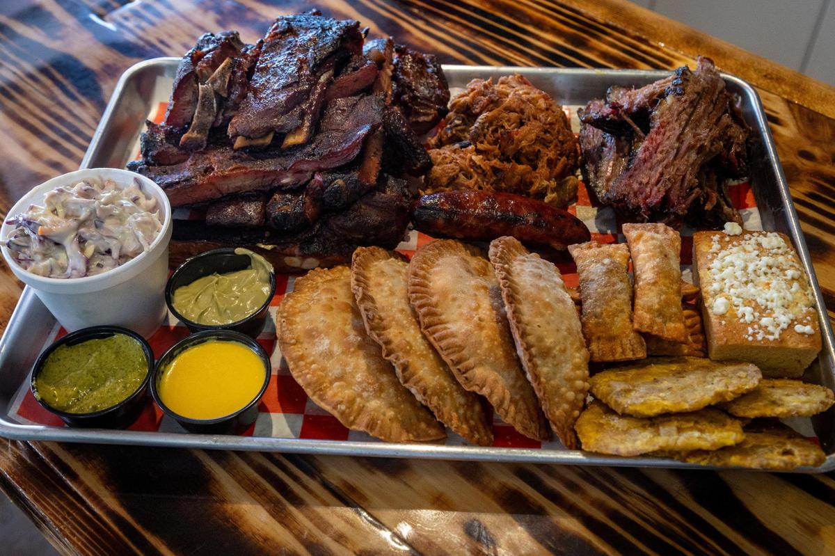 A family dish called Pal Musico at La Veridica BBQ comes with four empanadas, four tequeños, one whole chicken, one sausage, a half pound of brisket, a full rack of ribs and pulled pork.