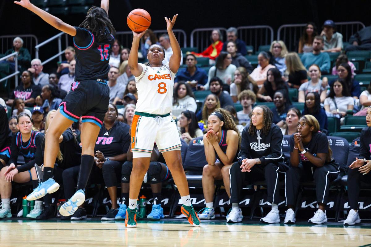 Miami Hurricanes Darrione Rogers(8) shoots a three pointer while FIU’s Fantasia James (15) jumps in front of her during the second quarter of a game on Tuesday, Nov. 19, 2024, at Watsco Center in Coral Gables, Fla.
