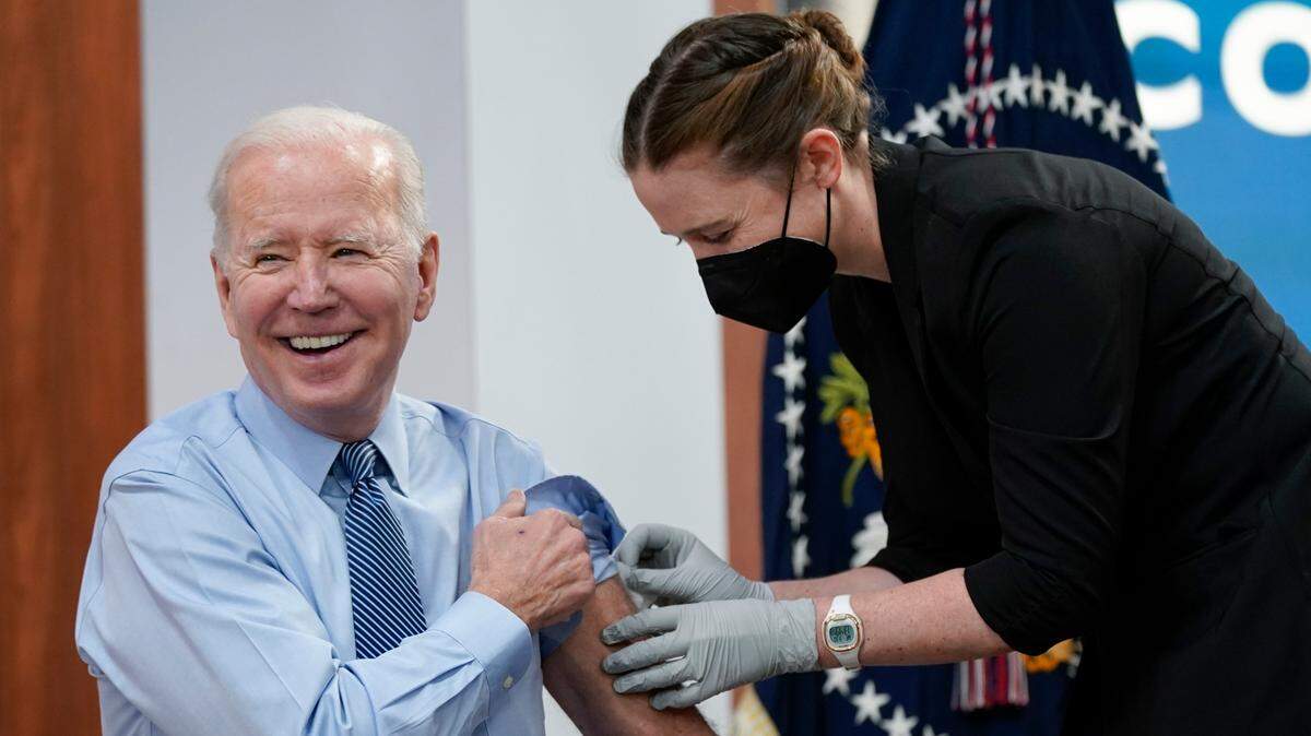 In this photo, President Joe Biden smiles after receiving his second COVID-19 booster shot in the South Court Auditorium on the White House campus, Wednesday, March 30, 2022, in Washington.