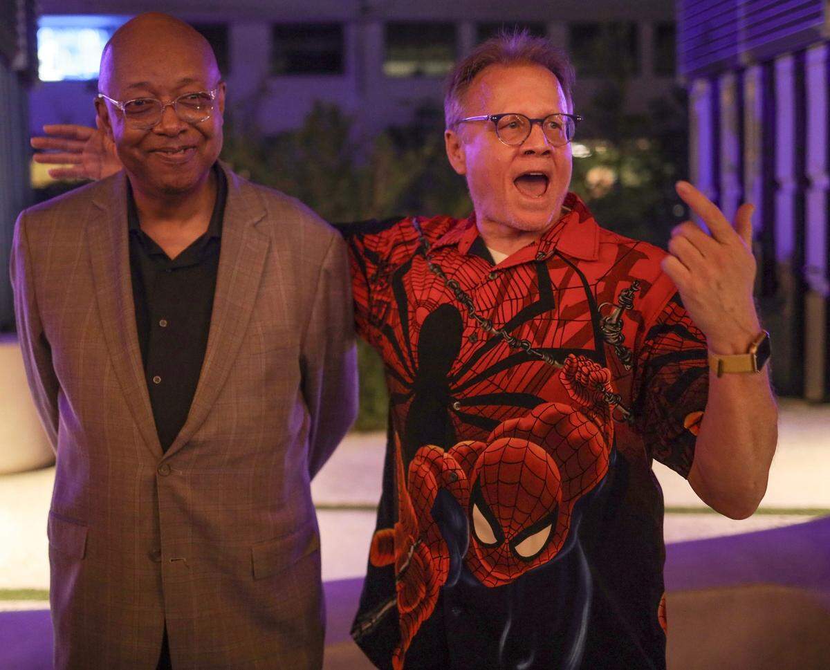 Leonard Pitts Jr. smiles as his Miami Herald colleague and buddy Howard Cohen emcees Pitts’ farewell party put together by Herald colleagues in Wynwood on Dec. 8, 2022. Cohen and Pitts worked together on the pop music beat for the Herald in the early 1990s. Cohen’s Spider-Man shirt was chosen in Pitts’ honor. The Pulitzer winner has oft-cited Marvel Comics founder and Spider-Man co-creator Stan Lee as an inspiration for his writing.