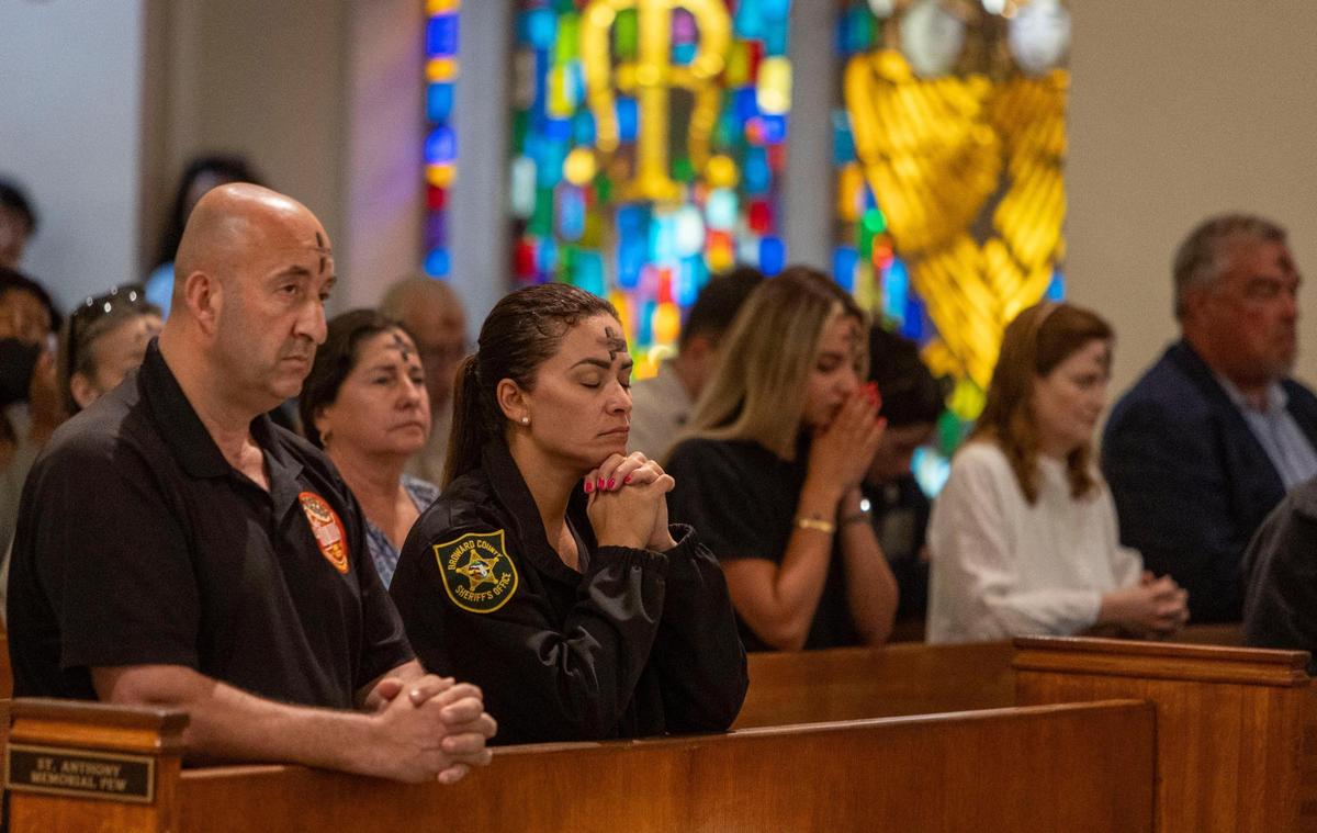Churchgoers pray during mass on Ash Wednesday at St. Anthony Church in Fort Lauderdale, Florida.