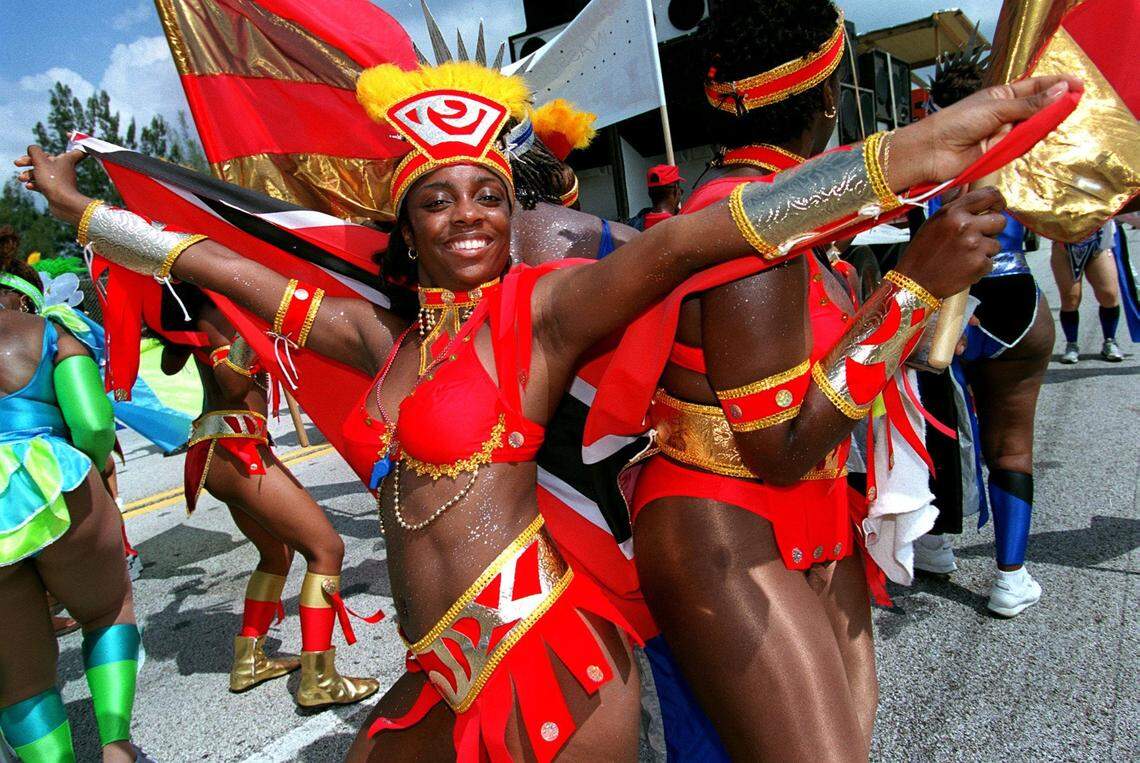 With a Barbados flag over her shoulders, Nancy Coakland struts her stuff in the 13th Miami Carnival in 1999. A total of 36 bands featuring thousands of participants from Barbados, Jamaica, Trinidad and Tobago, The Bahamas and other islands joined the party in Opa-locka.
