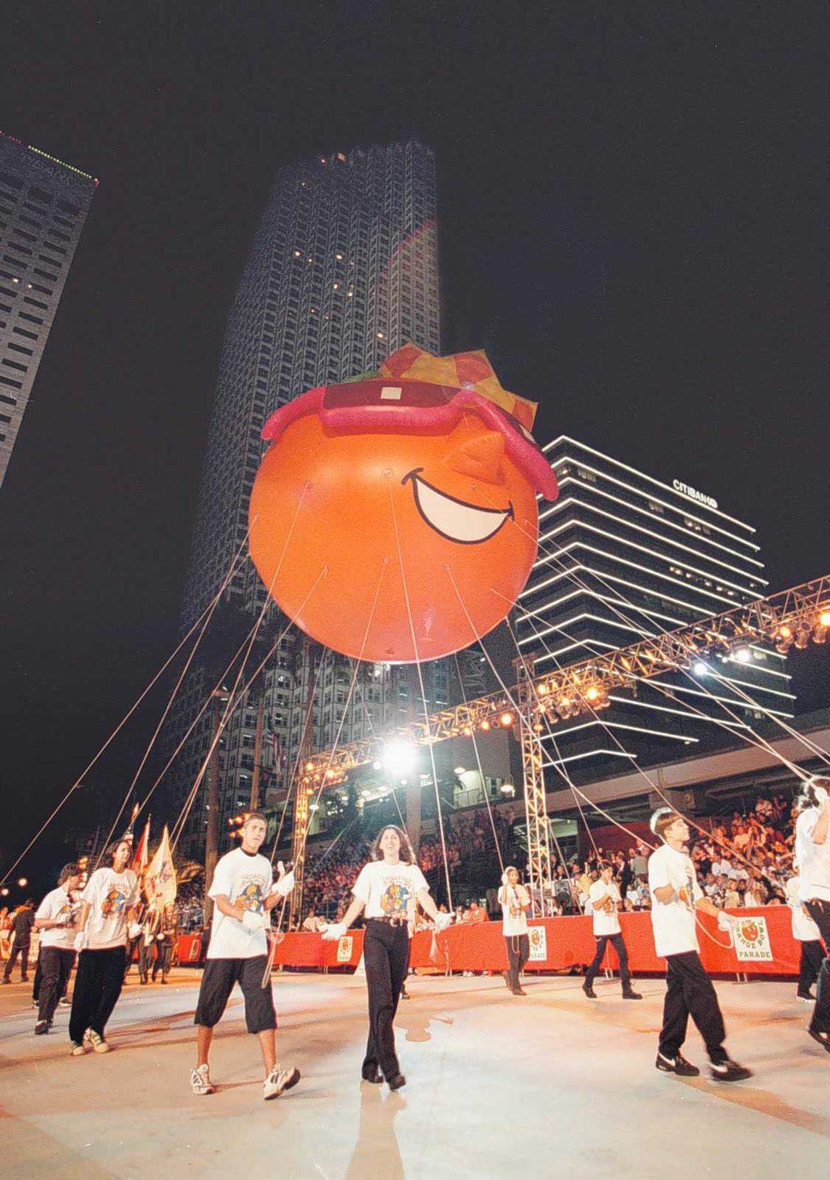 In this 1996 file photo, the King Orange balloon makes its way down Biscayne Boulevard in downtown Miami during the annual Orange Bowl Parade.