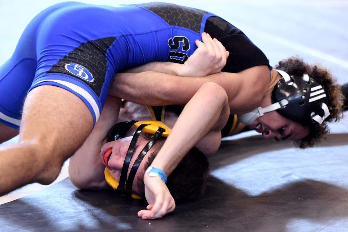 South Dade’s Obby Encarnacion picks up a pin victory against Deland’s Tyler Bracero during a 113-pound 3A semifinals match at the FHSAA Duals Wrestling State Championships on Saturday at Osceola High School in Kissimmee.