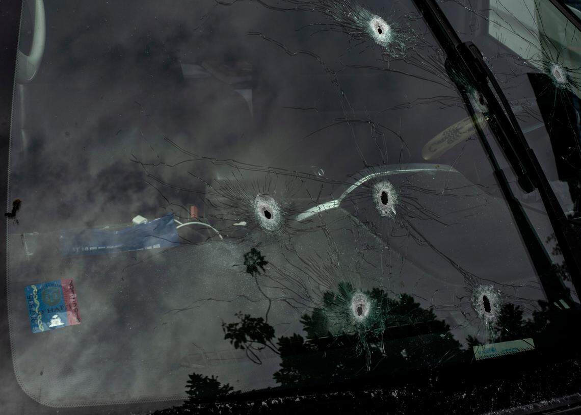 Bullet holes cover the windshield of journalist Roberson Alphonse’s car after he was attacked in Port-au-Prince, Haiti, Tuesday, Oct. 25, 2022. Alphonse, who works at the daily newspaper Le Nouvelliste and radio station Magik9, is hospitalized but is expected to recover, according to Frantz Duval, chief editor for both media. He said Alphonse has undergone two operations so far.