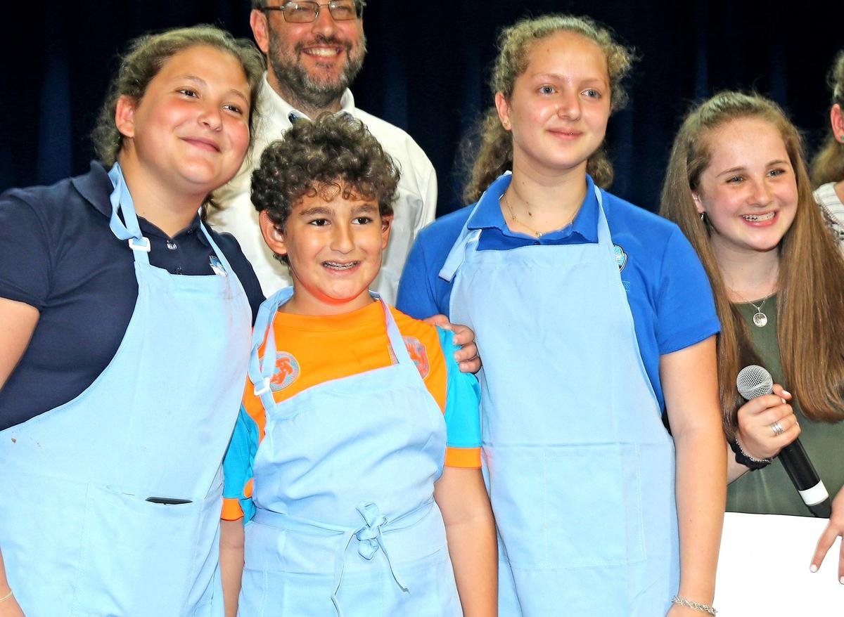 Team Light Blue — Esther Ohev-Zion, Issac Ohev-Zion, and Ariella Bitton — winners of the Scheck Hillel Community School cooking contest with judge Rachel Goldzal, 13.