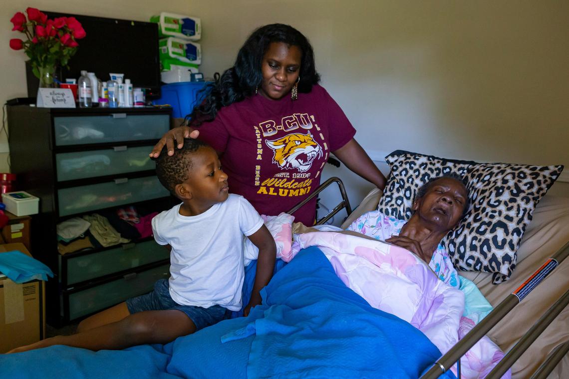 From left: Grayson Kelley, 4, his mom, Schyler Watson, 34, and his grandmother, Barbara Wilson, live at their home in Miami Gardens, Florida, on Saturday, May 9, 2020. Watson is a single mom working from home and also caring for her 73-year-old mother, who has dementia.