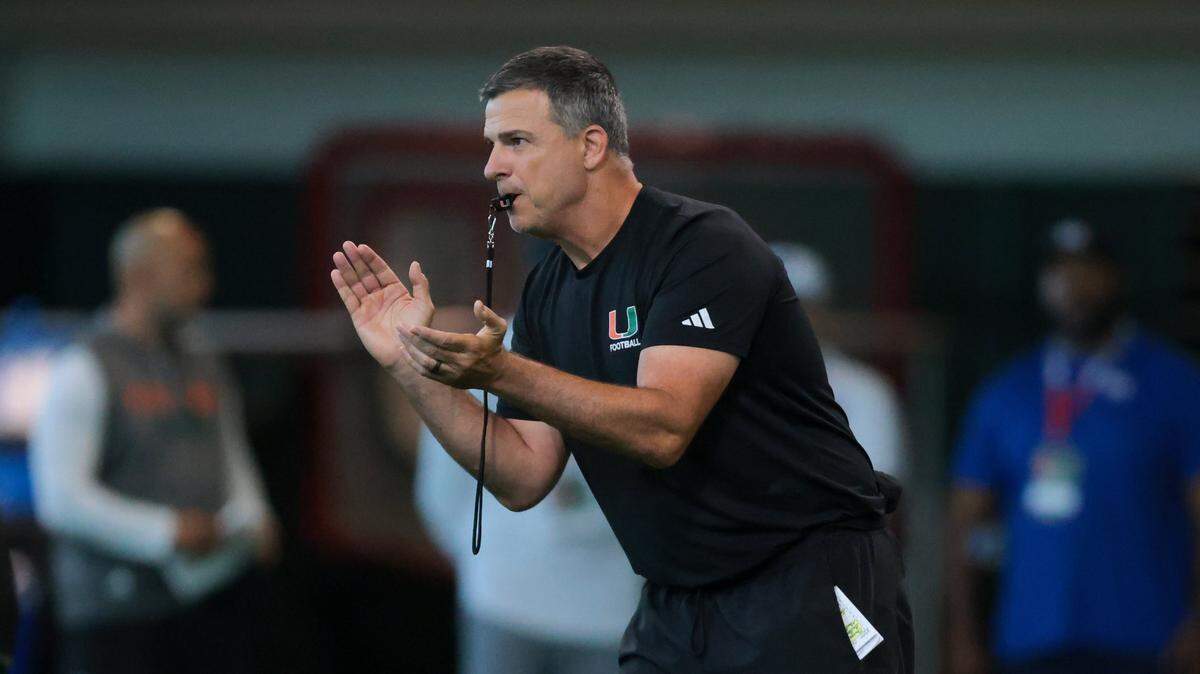 Miami Hurricanes head coach Mario Cristobal blows a whistle during football practice at the Carol Soffer Indoor Practice Facility at the University of Miami in Coral Gables, Florida, on Thursday, Aug. 7, 2025.