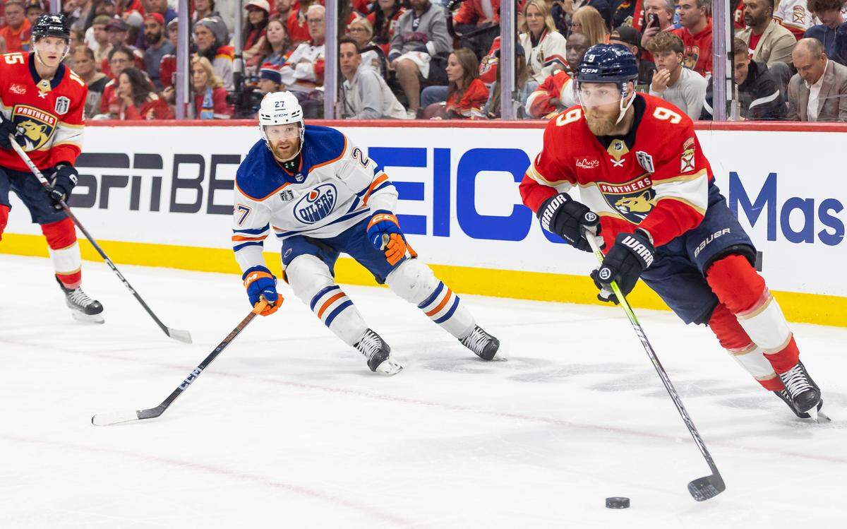 Florida Panthers center Sam Bennett (9) skates with te puck as Edmonton Oilers defenseman Brett Kulak (27) defends in the third period of Game 1 of the NHL Stanley Cup Finals at the Amerant Bank Arena on Saturday, June 8, 2024, in Sunrise, Fla.