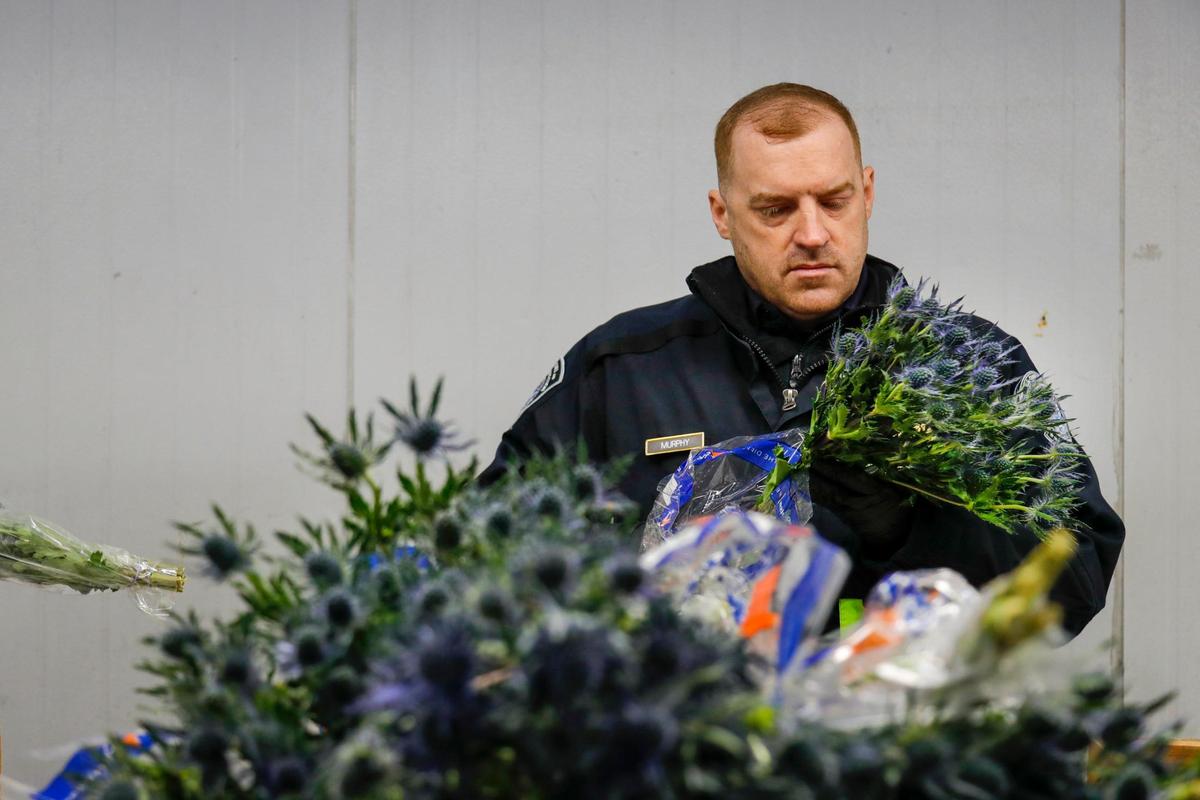 An agriculture specialist from U.S. Customs and Border Protection inspects flowers for harmful pests arriving at Miami International Airport on Monday, February 6, 2023.
