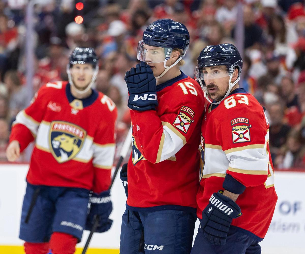 Florida Panthers centers Anton Lundell (15) and Brad Marchand (63) talk as they play against the Carolina Hurricanes in the first period of Game 3 during the Eastern Conference final of the NHL Stanley Cup playoffs at Amerant Bank Arena on Saturday, May 24, 2025, in Sunrise, Fla.