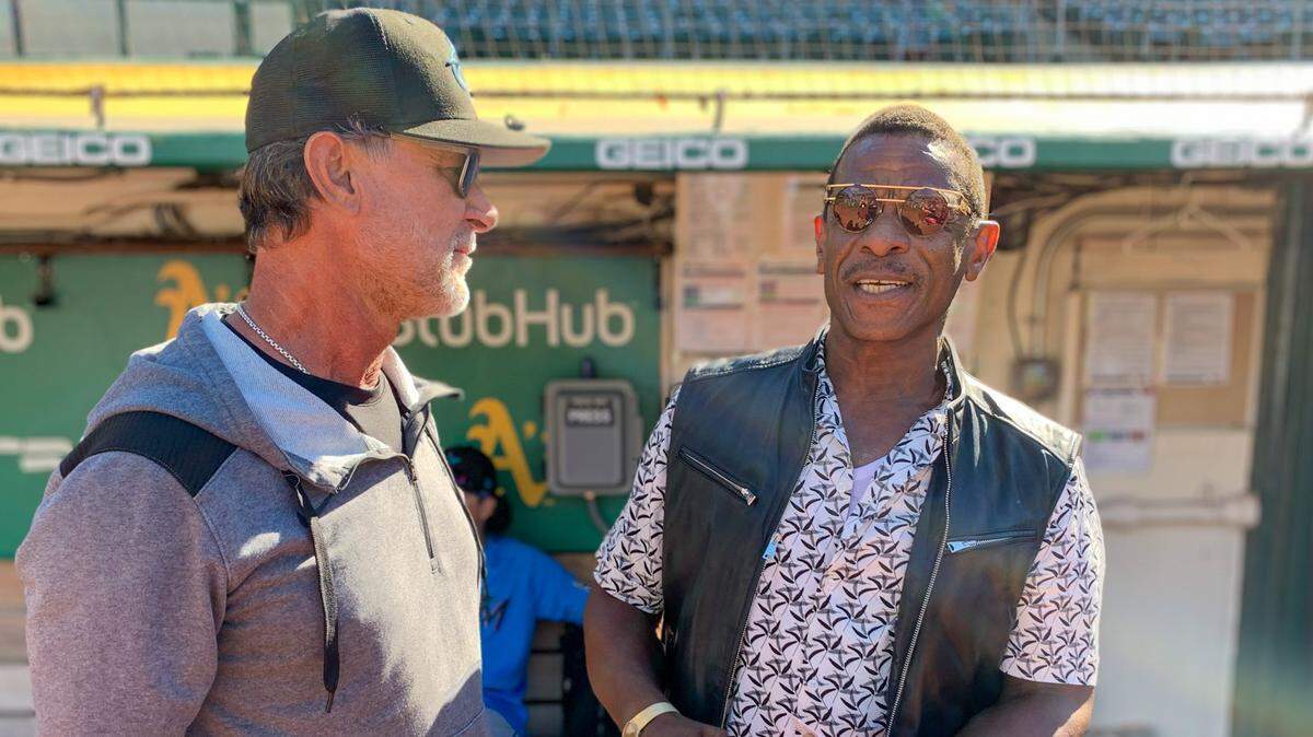 Miami Marlins manager Don Mattingly (left) and Hall of Famer Rickey Henderson (right), teammates for five seasons with the New York Yankees, catch up on the field at RingCentral Coliseum on Tuesday, Aug. 23, 2022.