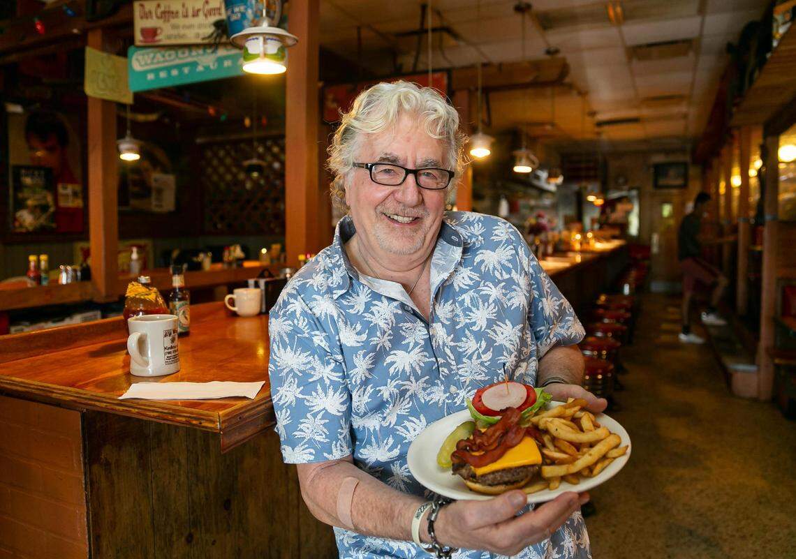Walter 'Wally' Muench, the owner of Wagons West Restaurant, prepared a bacon cheeseburger at his diner on Friday, July 1, 2022, in Pinecrest, Fla.