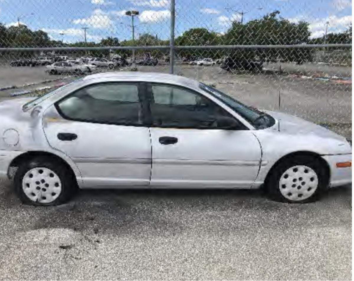 A neglected car sits in the parking lot of a Miami-Dade County public school. The car was supposed to be used for driver education.